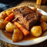 A tender pot roast served with roasted potatoes and carrots, perfect for Sunday dinner ideas.