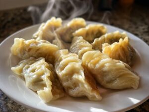 A plate piled high with freshly steamed and lightly pan-fried Traditional Chinese Dumplings, showing visible steam rising.