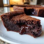 Close-up of a slice of chocolate pudding cake showing the molten, gooey center.