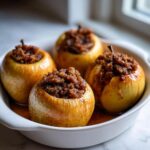 Four golden baked apple desserts filled high with a brown sugar and spice crumble topping.