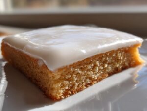 Close-up of a square baked good topped with thick, smooth sugar cookie icing that hardens perfectly.