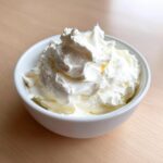 A white bowl filled with thick, creamy white mixture, the base for the 5-Minute garlic sauce.